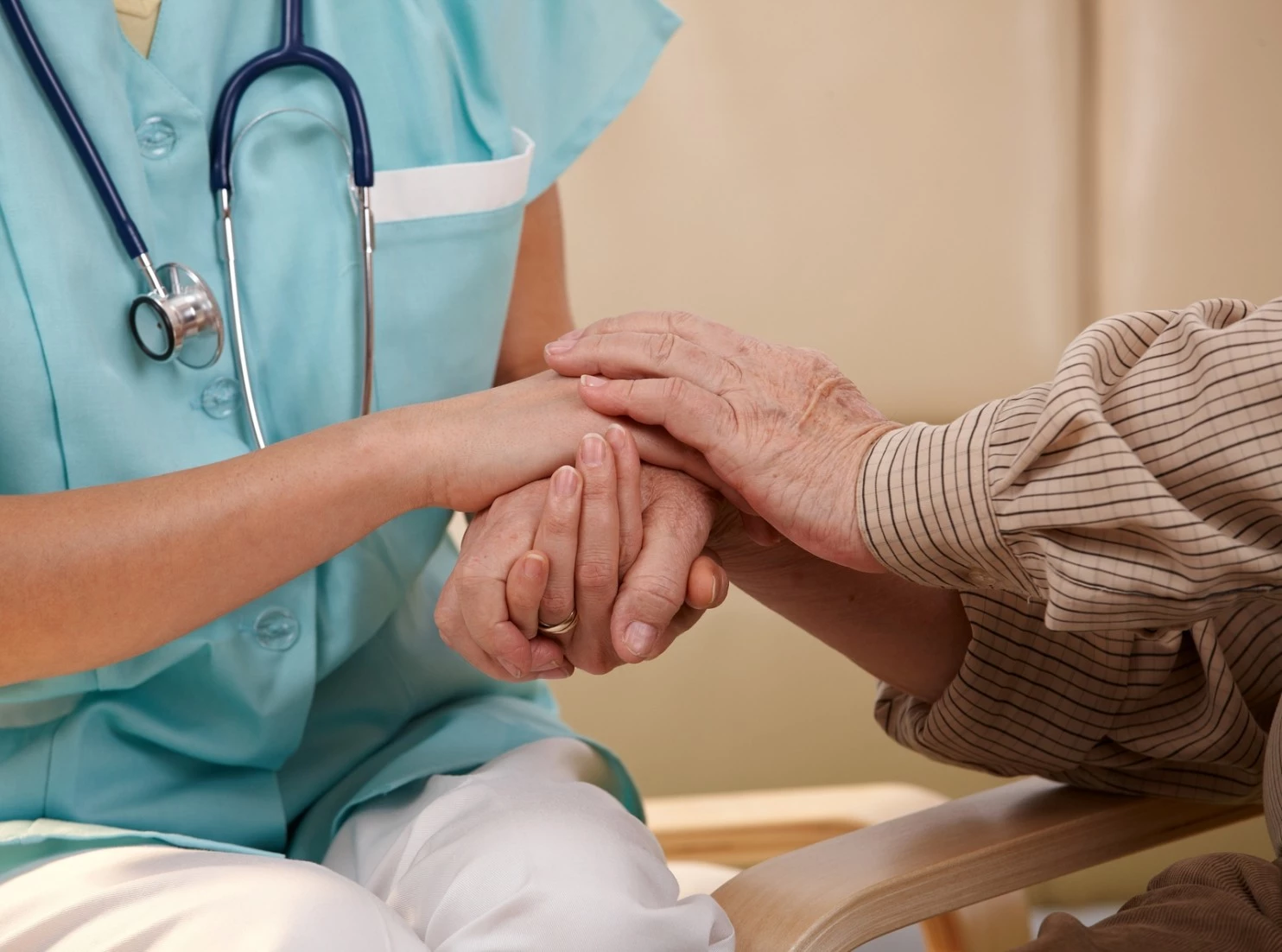 Nurse holding patients hands during eeoicpa diagnosis